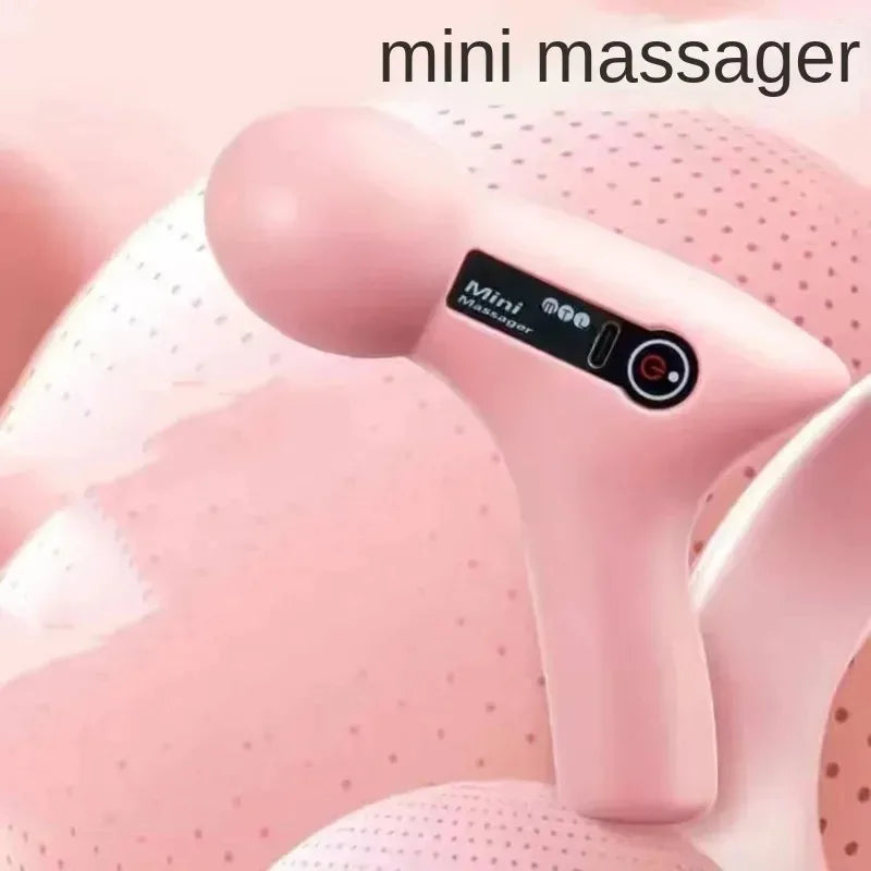Mini pink electric massager with a digital display against a soft pink background.